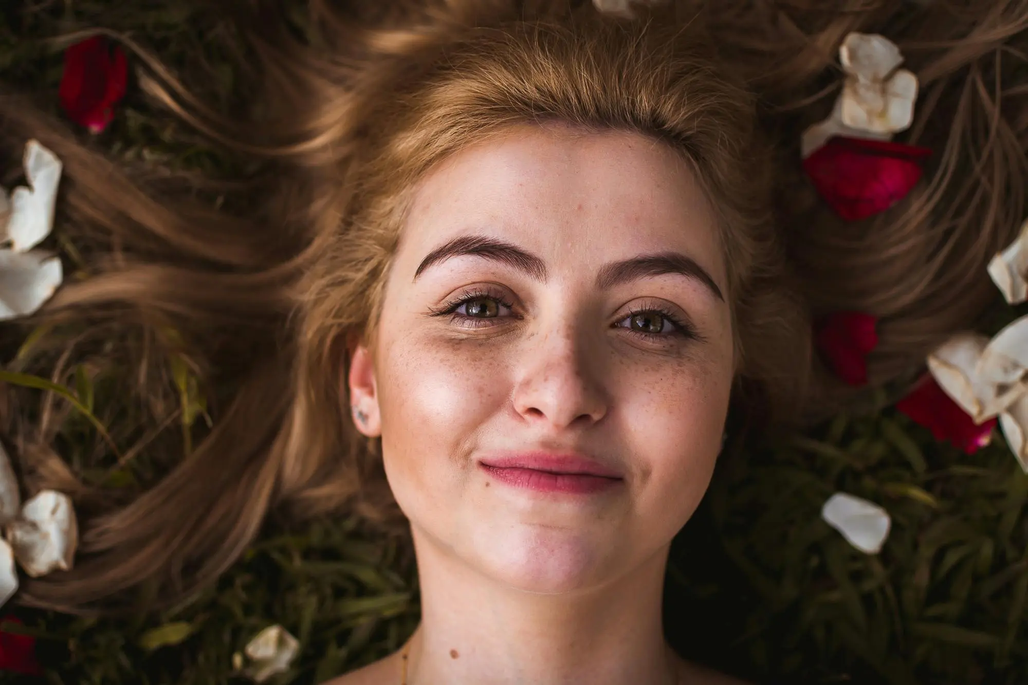 girl laying down in flower field